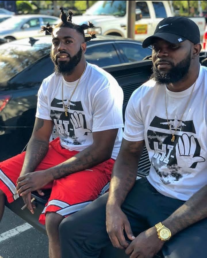 Two men wearing white High 5 tees
